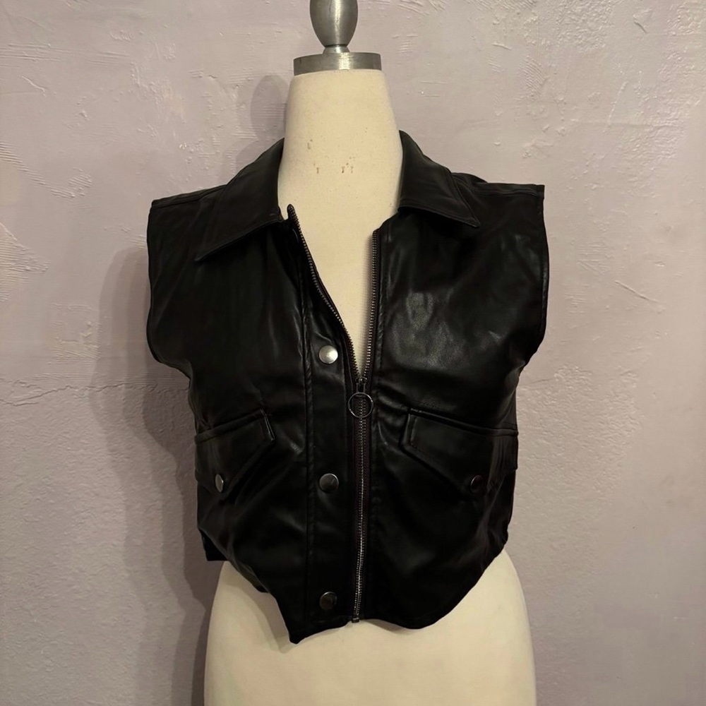 Woman’s black zip up vest